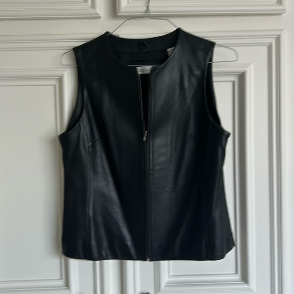 Beautiful black leather vest by Valerie Steven’s. 23 inches long and 20’ wide